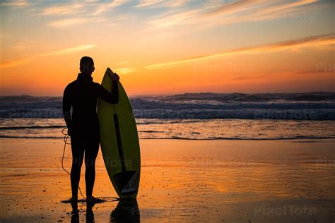 Surfboards On The Beach At Sunset