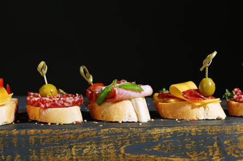 Premium Photo Tasty Sandwiches On Wooden Table On Black Background