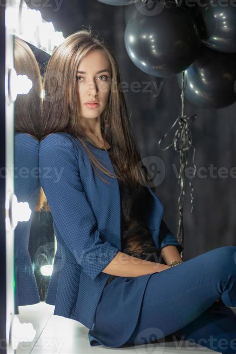 Beautiful Brunette Posing While Sitting Stock Photo At Vecteezy