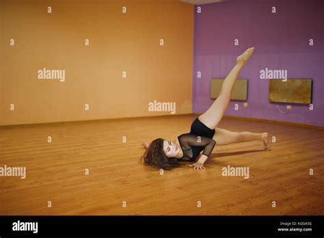 Curly Brunette Plus Size Model Doing Acrobatic At Dance Room Stock
