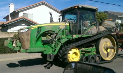 A Tractor Is Parked In Front Of A House