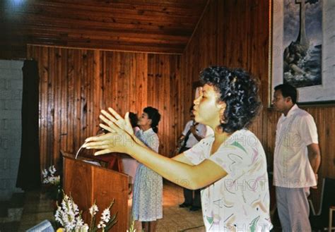 R Woman Singing During A Worship Service In A Small Church In