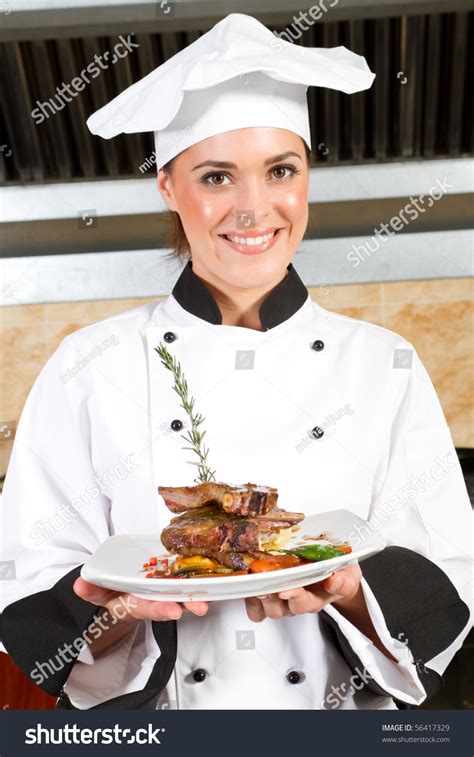 Young Beautiful Female Chef Presenting Food In Kitchen Stock Photo ...