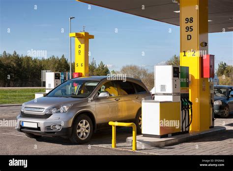 Car In Gas Station Fuel Petrol Dispenser And Pillars Fueling