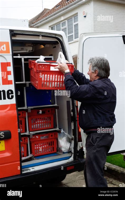 iceland home delivery driver unloading order outside of customers house ...