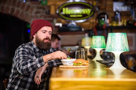 Premium Photo Hipster Hungry Man Eat Burger Man With Beard Eat