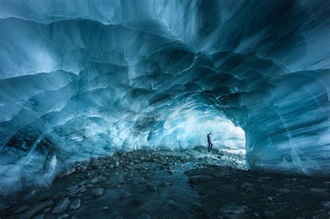 Hiker Silhouette Exploring An Ice Cave In The Furgg Glacier In Zermatt