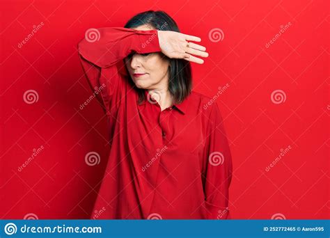 Middle Age Hispanic Woman Wearing Casual Clothes Covering Eyes With Arm