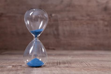 Premium Photo A Side View Of An Hourglass With Falling Sand