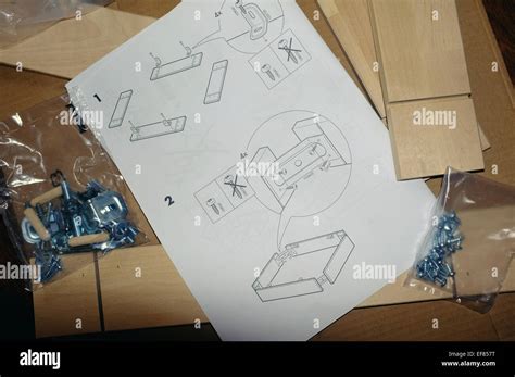 A sheet of Ikea furniture assembly instructions next to assembly ...