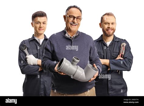 Portrait Of A Mature Man Holding A Plastic Pipe And Plumbers Standing