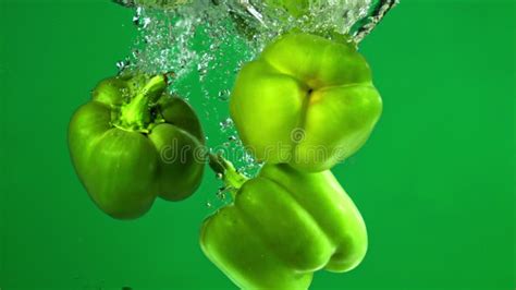 Green Sweet Pepper Falls Under Water Filmed On A High Speed Camera At