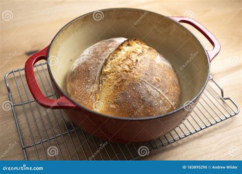 Homemade Boule Round Loaf Of Freshly Baked Sourdough Bread In A Red