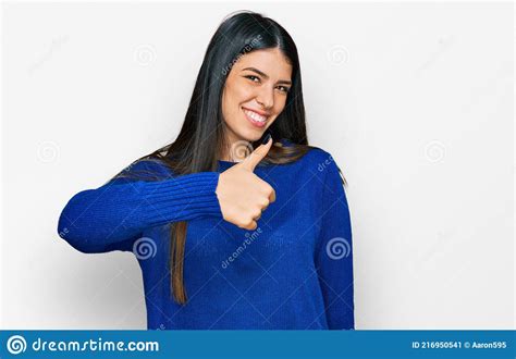 Young Hispanic Woman Wearing Casual Clothes Doing Happy Thumbs Up