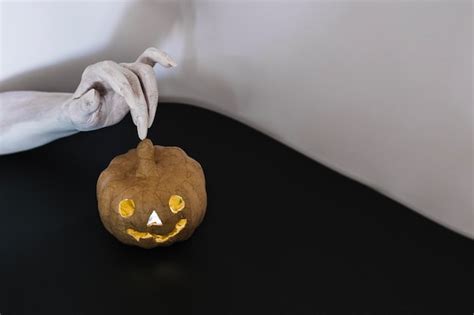 Free Photo Witch Hand Touching Jack O Lantern