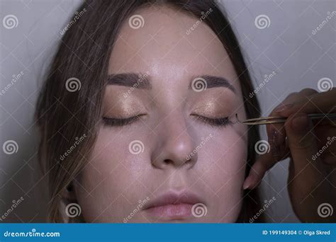 The Process Of Applying Makeup To A Beautiful Brunette Beauty Modeling And Cosmetics Concept