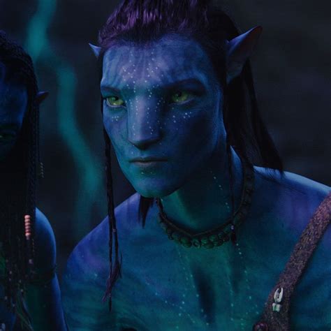 Two Avatars With Green Eyes And Blue Skin Are Standing In Front Of Each