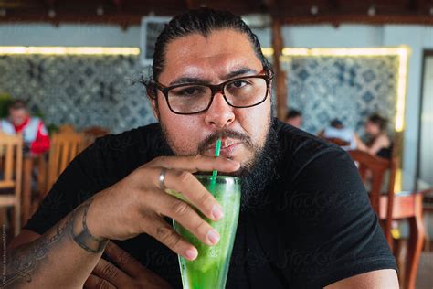 Man Having A Drink In A Restaurant By Stocksy Contributor Kike