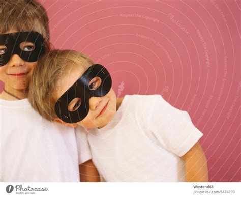 Portrait of two smiling little boys wearing black eye masks - a Royalty ...