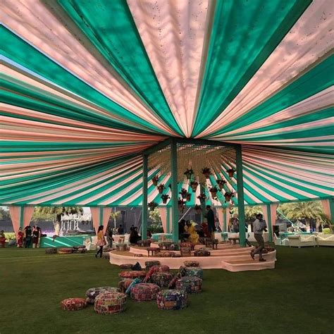 the inside of a large tent with people sitting under it