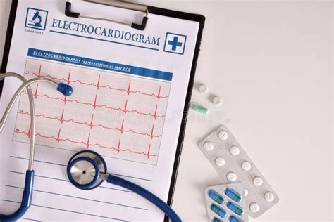 Clipboard With Electrocardiogram And Treatment Of Tablets On Tab Stock