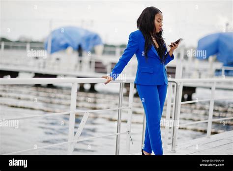 Success African American Business Woman At Blue Suit With Mobile Phone