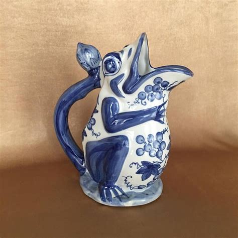 A Blue And White Ceramic Figurine Sitting On Top Of A Wooden Table Next