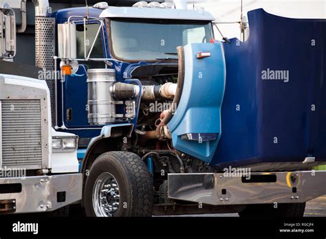 Blue Classic American Bonnet Big Rig Semi Truck With Open Hood Standing