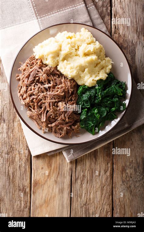 Botswana Cuisine Seswaa Beef Stew With Pap Porridge And Spinach Close Up On A Plate On A Table