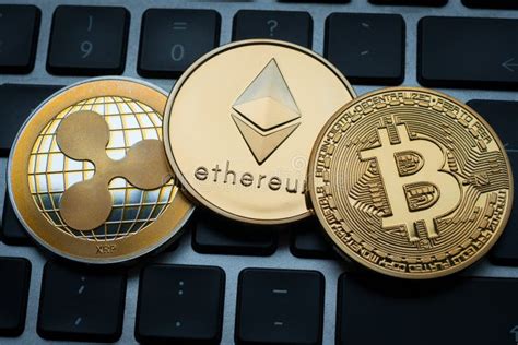 Cryptocurrencies Ethereum Ripple And Bitcoin Coins On Computer Laptop