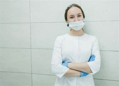 Premium Photo Young Woman Dentist In White Coat