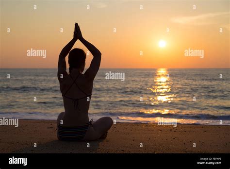 Sunset yoga on the beach Stock Photo - Alamy