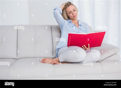 Calm Blonde Sitting On Couch Reading Notebook Stock Photo Alamy