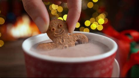 Dipping A Gingerbread Man Biscuit In A Cup Of Hot Chocolate In Slow
