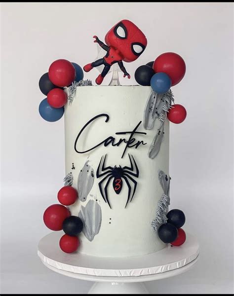 A Spiderman Cake Is Decorated With Red White And Blue Balloons