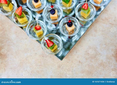 Assorted Canapes Of Fruit And Cheese On A Glass Platter On The ...