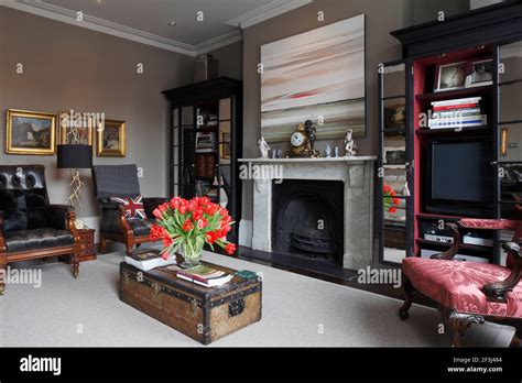 Sitting Room With Marble Fireplace Pair Of Black Leather Button Backed