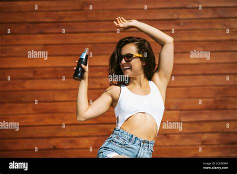 Beautiful Brunette Girl Raising Her Arm And Smiling Stock Photo Alamy