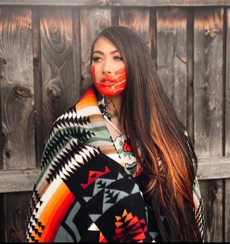 A Woman With Painted Face Standing In Front Of A Wooden Fence