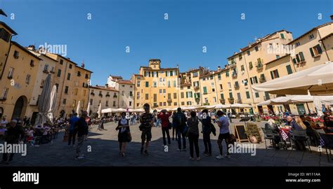 Tourists Visit The Ancient Town Square Piazza Dell Anfiteatro