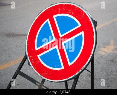 Round Road Sign With A Red Cross On A Blue Background A Sign Means A