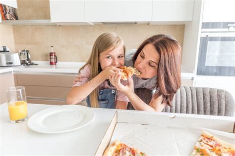 Mother And Daughter Eating A Tasty Pizza Stock Image Image Of