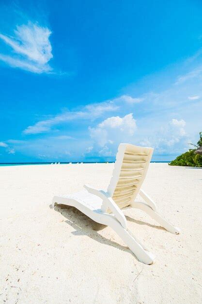 Premium Photo Deck Chairs On Beach Against Blue Sky