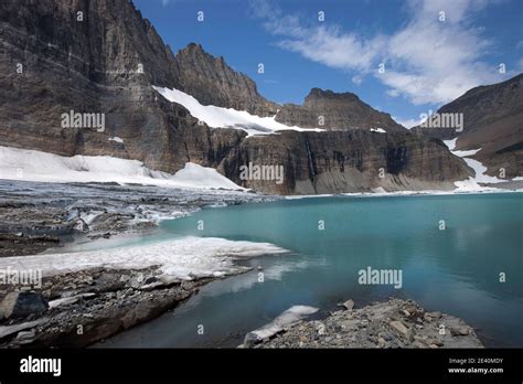 Glacial tarn and ice beneath headwall. Upper Grinnell Lake, Glacier National Park, Montana Stock ...