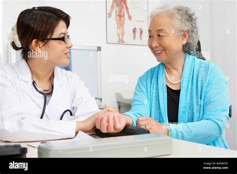 Doctor Checking Patient S Pulse Stock Photo Alamy