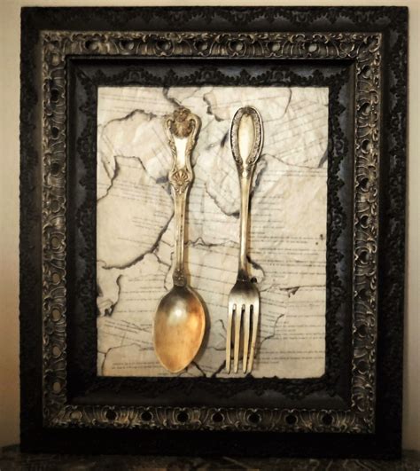 Antique Frame Surrounds A Silver Leaf Large Fork And Spoon The