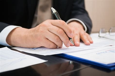 Premium Photo Detail Of A Businessman Writing On A Document