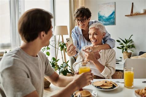 Lesbian Parents And Their Adult Son Stock Photo Image Of Tablescape Lgbtq