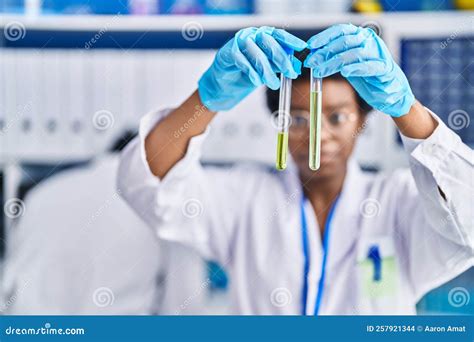 African American Man And Woman Scientists Holding Test Tubes At