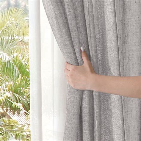 A Person S Hand Is Opening The Curtains In Front Of A Window With Palm